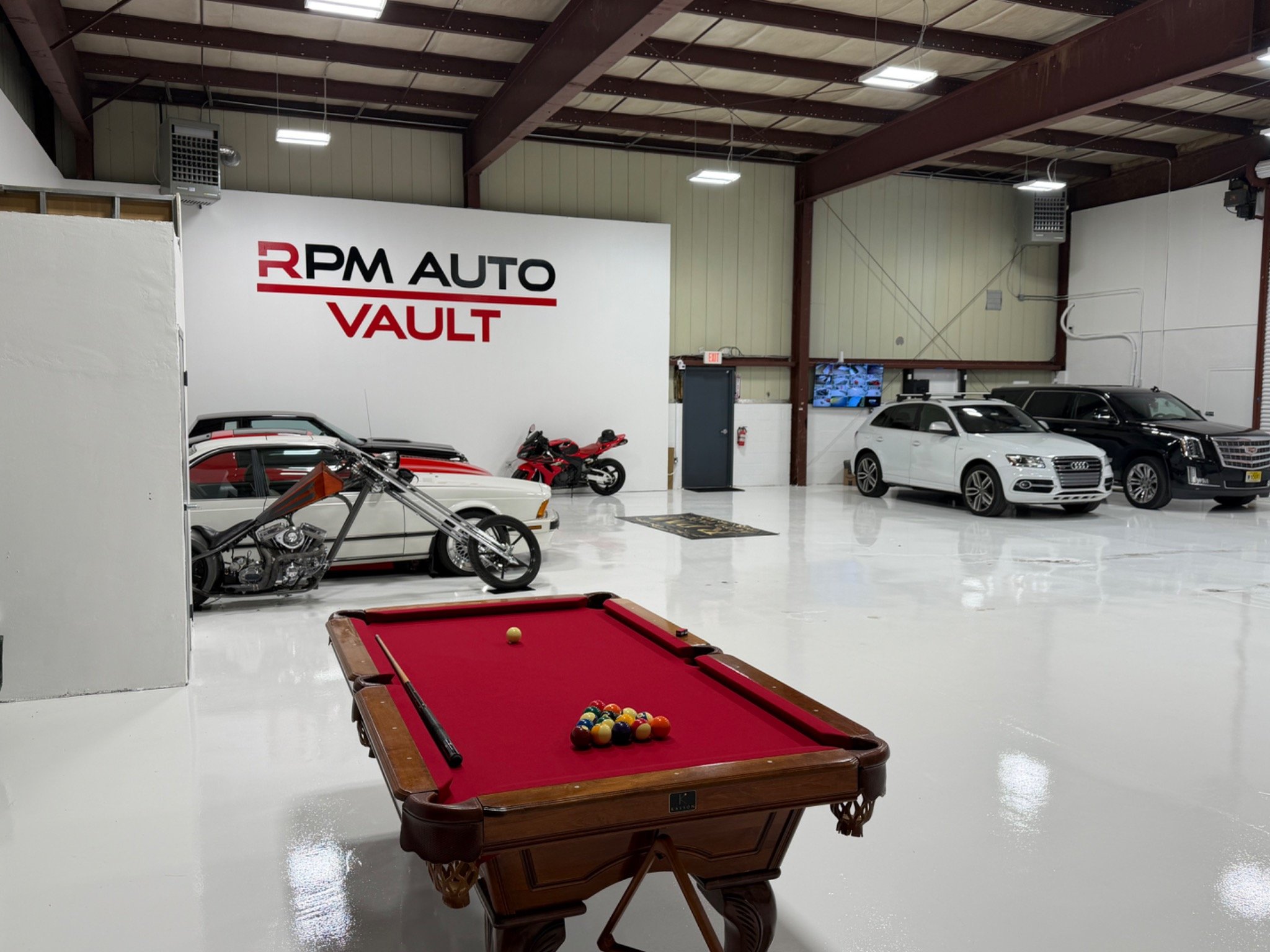 RPM Auto Vault facility interior with polished floors and stored vehicles